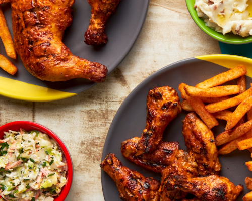 Nandos chicken wings and fries on a plate