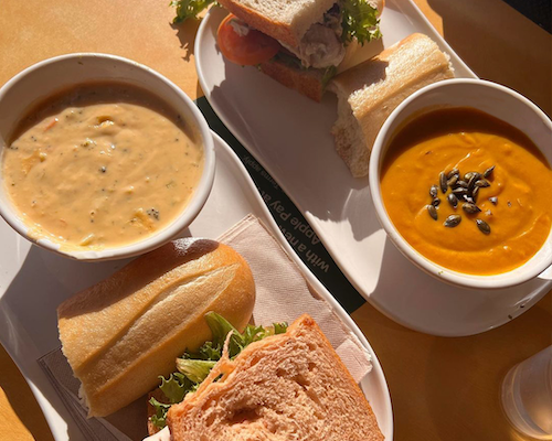 two Panera Bread soup and sandwich entrees on plates