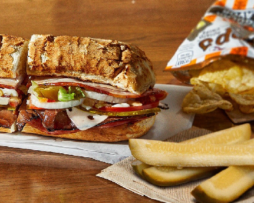 a potbelly sandwich with pickles and chips