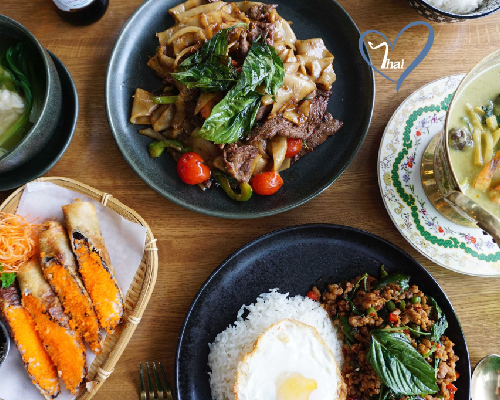 assorted thai food entrees on a table